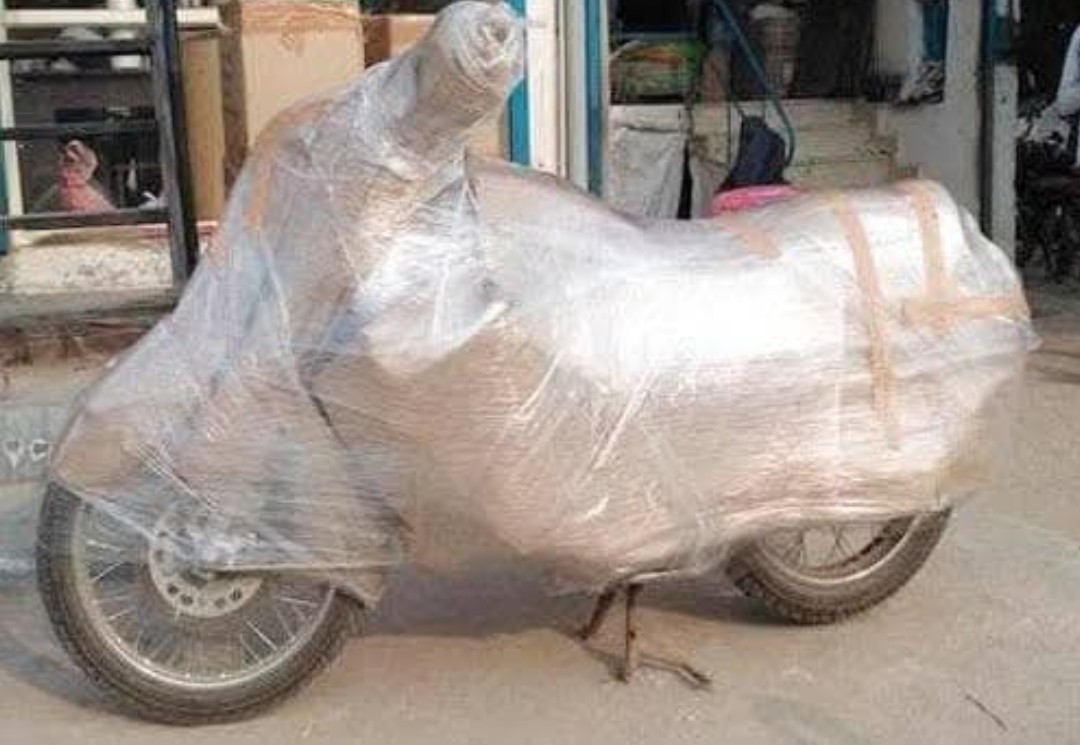Motorbike protected with stretch wrap for transportation